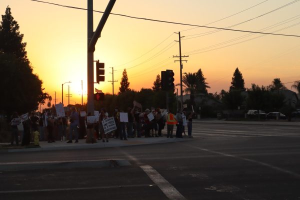 Protestors stand outside the Visalia First Assembly of God Church to voice their frustration against Charlie Kirk's appearance at the Tulare-Kings Resources for Life Advancing the Mission event during the sunset of Sept. 2.