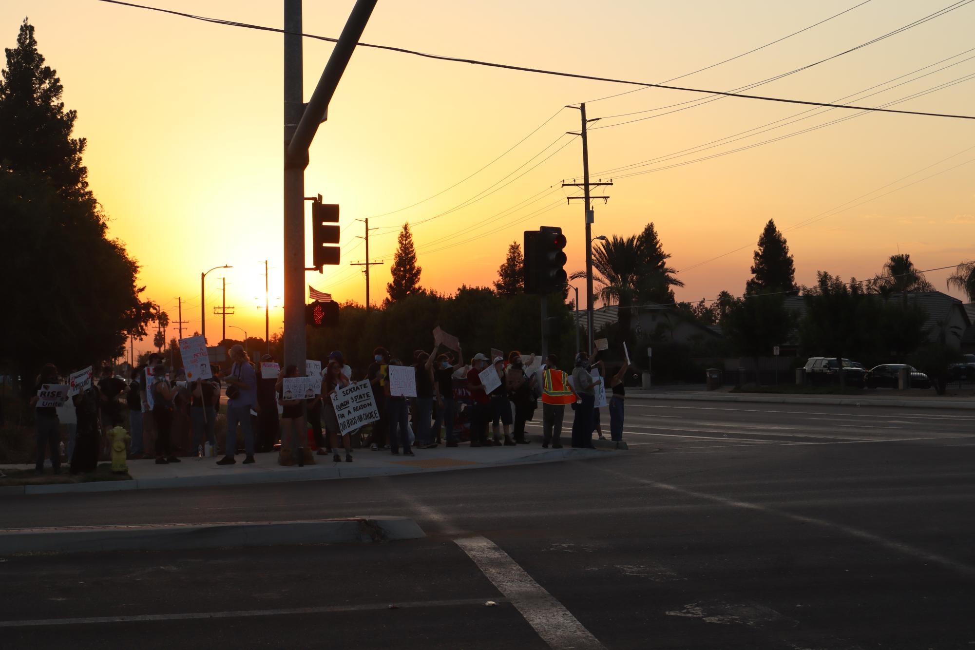 Protestors stand outside the Visalia First Assembly of God Church to voice their frustration against Charlie Kirk's appearance at the Tulare-Kings Resources for Life Advancing the Mission event during the sunset of Sept. 2.