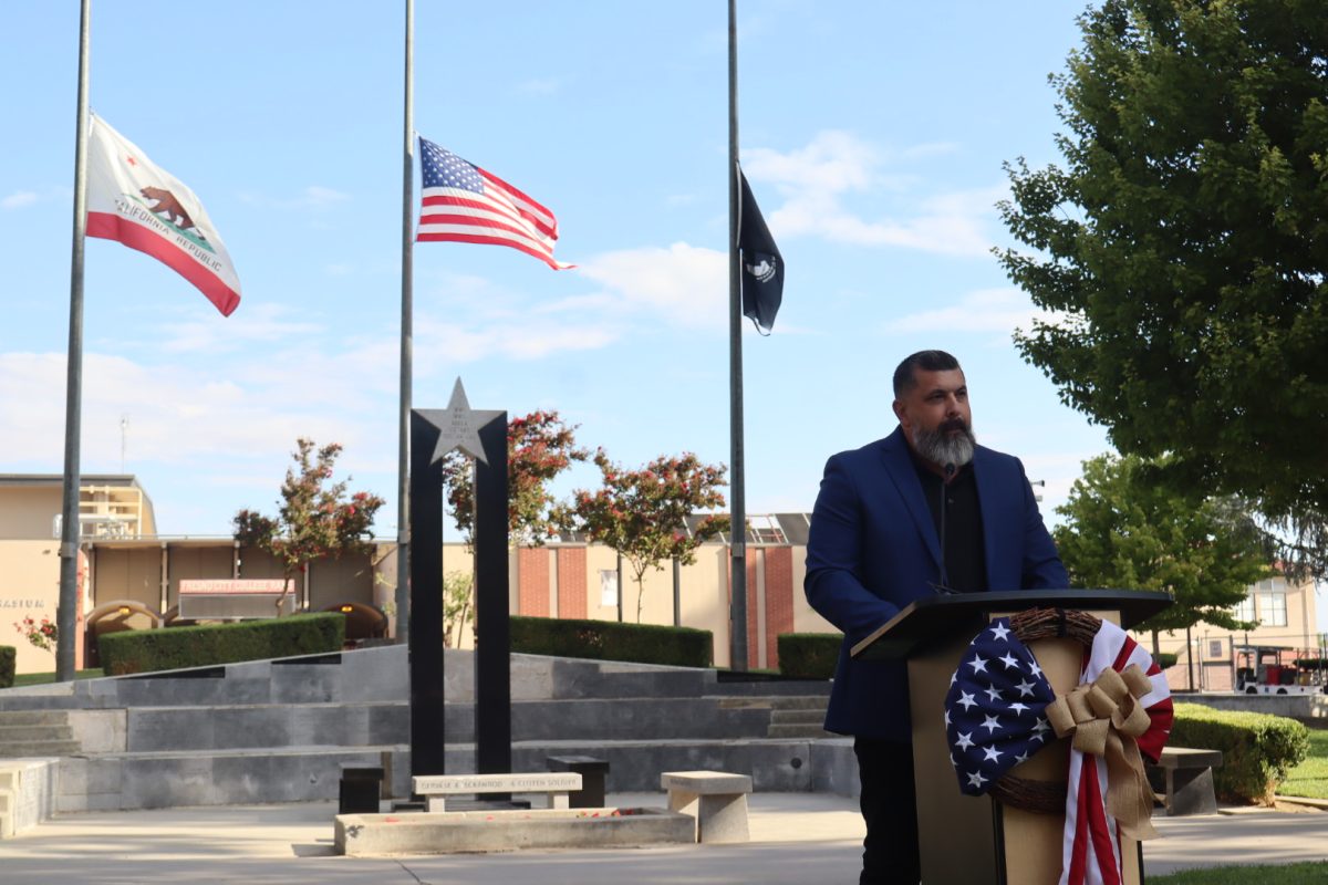 A photo of the 9/11 ceremony that took place on campus at Veterans Square, with keynote speaker Rick Jimenez taking the stage.