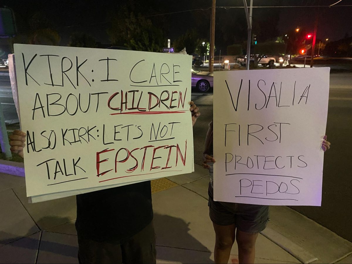 Two of the last remaining anonymous protestors stand with signs that read "Kirk: I Care About Children. Also Kirk: Let's Not Talk Epstein" and "Visalia First Protects Pedos" during the evening of Sept. 2 outside the Visalia First Assembly of God Church.