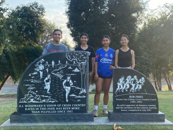 (left to right) Ryan Anderson, Emberly Gonzalez, Itzel Gonzalez and Julissa Thahane pose for a picture behind engraved stones dedicated to cross country at Woodward Park on Aug. 29.