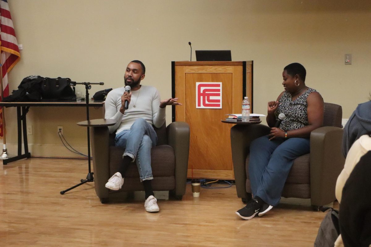 George M. Johnson (left) answering a question asked by Apryl Lewis (right) in the Old Administration Building 251 on Oct. 15.