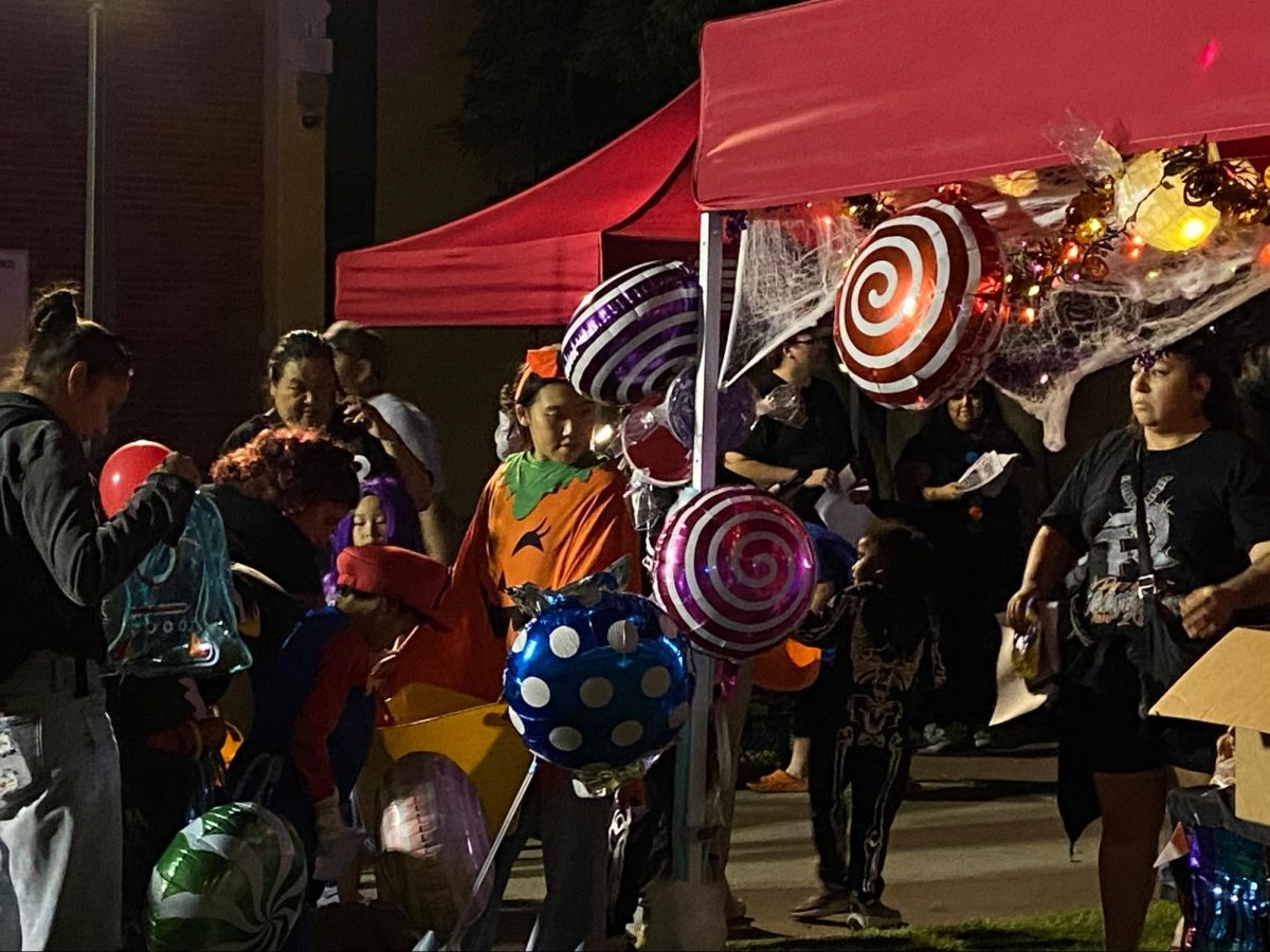 People dressed up taking candy at Fresno City College Fall Carnival on Oct. 24th