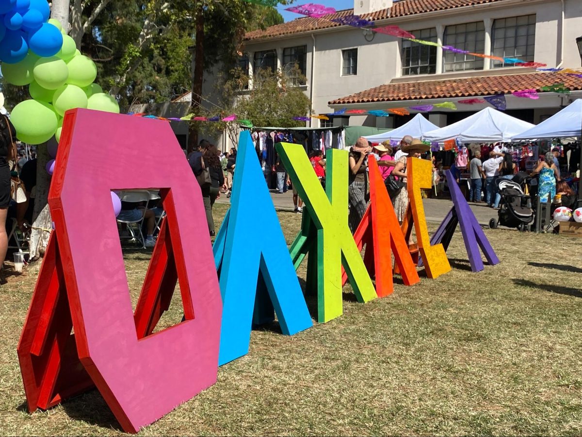 Painted wooden signs spell out “OAXACA” on the grass of Veteran’s Square on the Fresno City College campus during the 25th Annual Fresno Guelaguetza on Sept. 28.