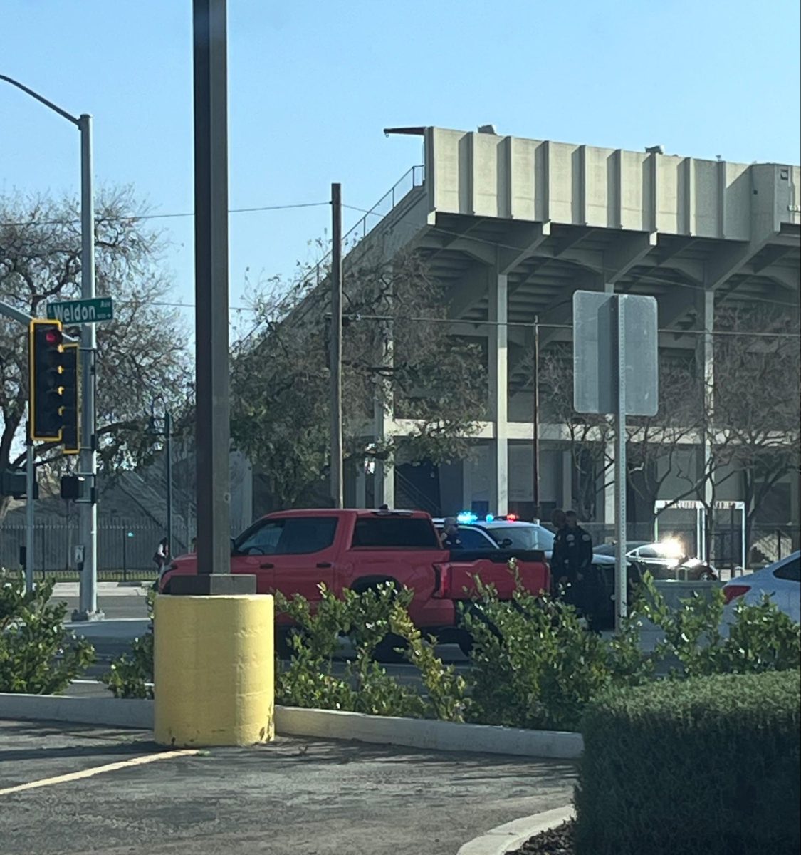 SCCCD police officers standing next to the fleeing driver’s orange pickup truck on Weldon and Blackstone Ave. on Jan 28.