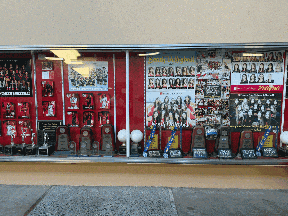  Trophy display case for women's volleyball and women's basketball. Trophies of state and conference championships are shown as well as hall of fame players and pictures of championship winning teams.