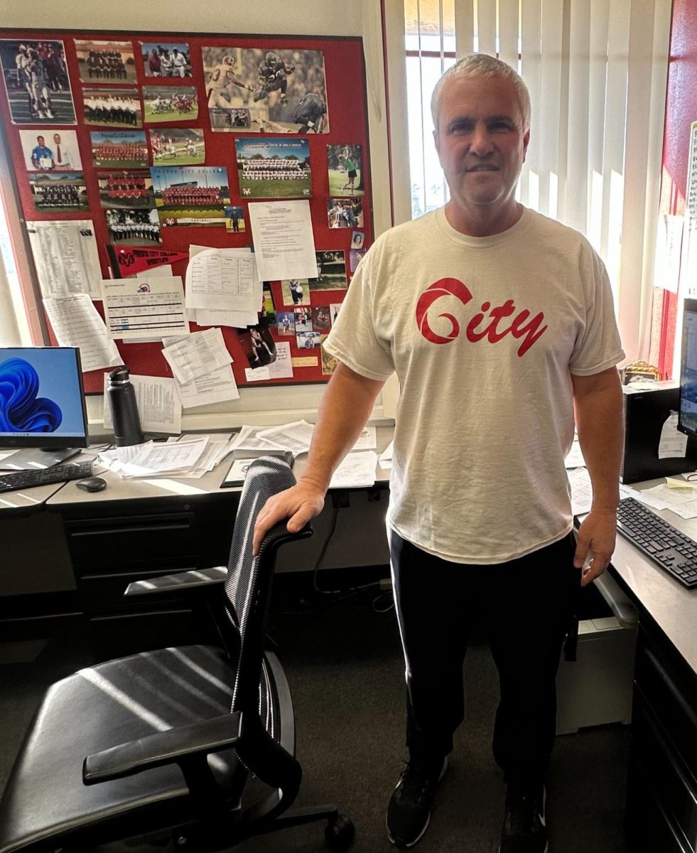 Coach Rick Scheidt standing in his office after being interviewed on Jan. 27.
