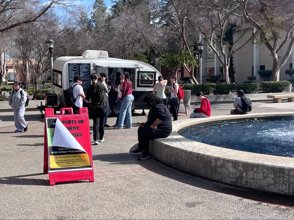 Students gather around Loving Seed, one of the latest food trucks seen on Fresno City College campus on Feb. 23.