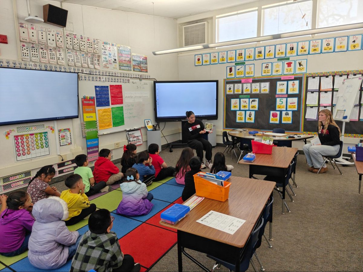 Alyssa Hernandez and Ashtyn Edwards taking turns reading to a class at Fremont Elementary on March 3.