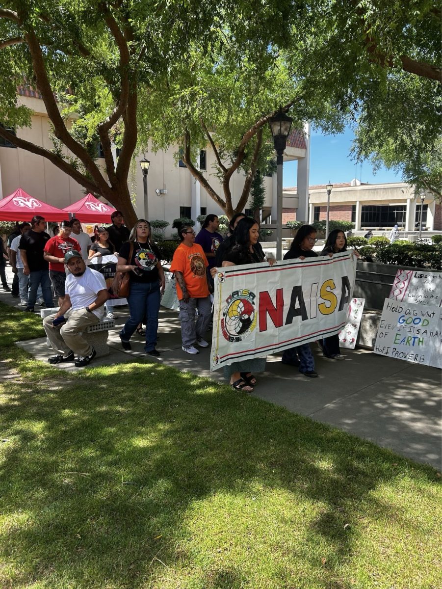 NAISA members walking the sidewalk of Yokuts Plaza at FCC on April 20.



